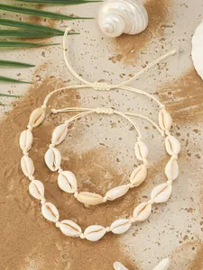 Dettaglio di un set di collana e bracciale fatti a mano con conchiglie in stile mare