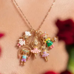 Detailed view of a golden necklace featuring five colorful cartoon doll charms on a neck
