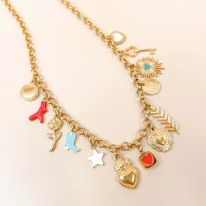 Close-up of 18K gold plated charm necklace with heart and star variety pendants