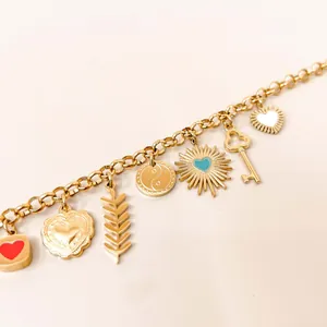 Close-up of 18K gold plated charm chain with heart, sun, and key pendants for DIY jewelry.