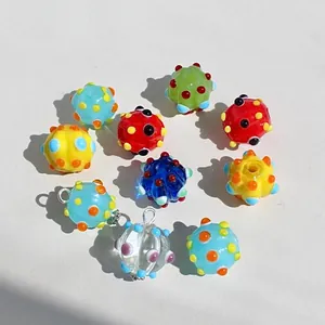 Detailweergave van kleurrijke lampwork glaskralen met stippen voor DIY-sieraden.