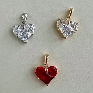 Detail view of heart-shaped zircon pendants in gold and silver finishes for DIY jewelry.