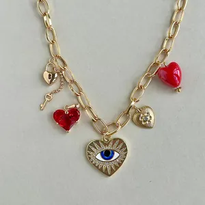 Close-up of a gold-tone stainless steel necklace featuring multiple heart charms