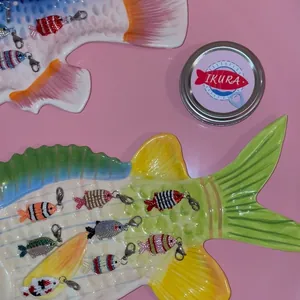 Macro view of colorful beaded fish charms featuring secure lobster clasp connectors