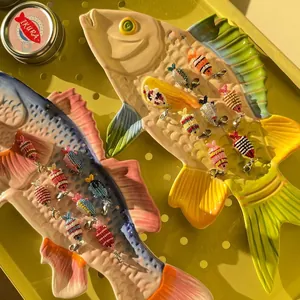 Close-up of handmade colorful beaded fish charms for ocean-themed DIY jewelry and crafts