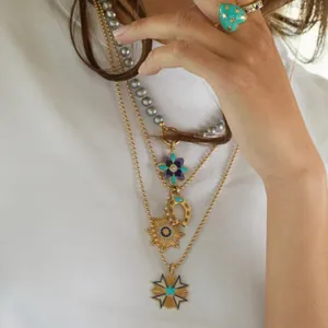 Detailed close-up of layered bohemian necklaces with horseshoe and starburst pendants