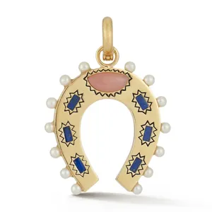 Detail shot of a gold-toned horseshoe pendant featuring pearls and colorful stones