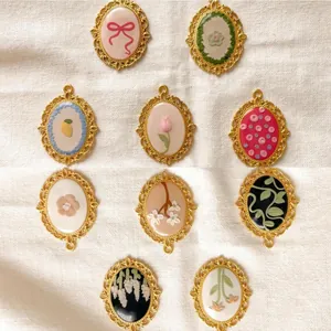 Selection of vintage gold filigree oval pendants with assorted floral and bow designs.