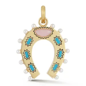 Detailed macro view of a gold horseshoe pendant with turquoise stones and white pearls