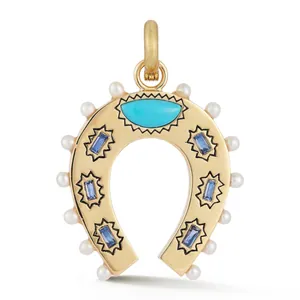Detailed macro view of a golden horseshoe pendant with turquoise stones and pearls