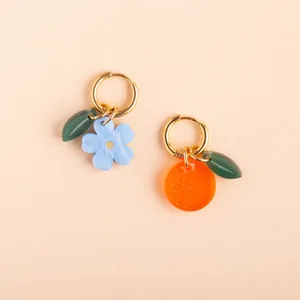 Close-up of colorful fruit and blue flower pendants for DIY stainless steel earrings