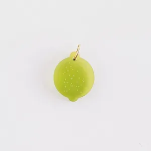 Detailed macro view of a translucent green lime-shaped pendant for DIY jewelry accessories
