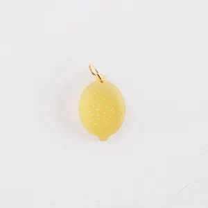 Close-up of yellow translucent lemon-shaped fruit pendant made of stainless steel