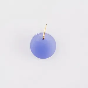 Close-up of a matte blue spherical pendant bead with a gold ring for DIY jewelry