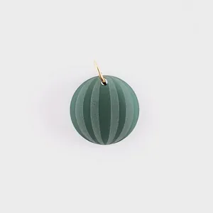 Detail view of green striped spherical stainless steel pendant for DIY jewelry