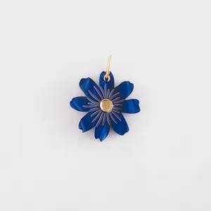Close-up of a vibrant blue layered flower pendant with a detailed textured gold center