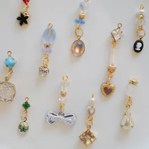 Exquisite macro shot of versatile jewelry pendants with bows, heart shapes and colorful gems.