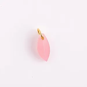 Detail of a pink leaf-shaped resin pendant with a gold stainless steel hoop for DIY jewelry.