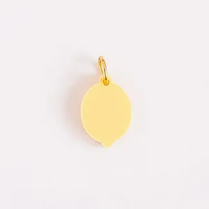 Detailed macro view of a golden stainless steel lemon pendant for DIY jewelry making crafts.
