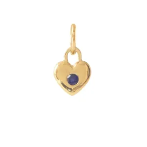 Detail of a vintage heart pendant in 18K gold plated stainless steel with a blue gem.