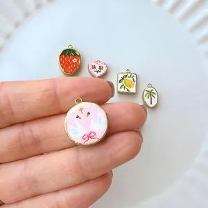 Detailed view of colorful enamel stainless steel pendants with various cute patterns.