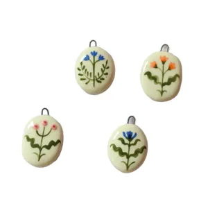 Minimalist set of four ceramic pendants with colorful hand-painted flower designs