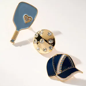 Set of sports themed enamel charms featuring a paddle, golf ball, and baseball cap.