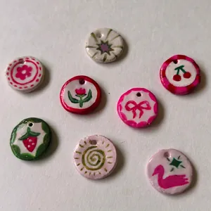 Hand-painted dopamine style DIY pendants featuring strawberry, cherry and bow designs