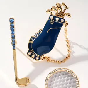 Detailed view of enamel golf bag and club pendants with pearls and blue rhinestones