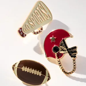 Detailed view of American football themed enamel pins with rhinestones
