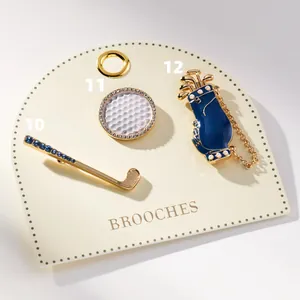 Detailed close-up of premium gold-plated golf-themed brooches for sports enthusiasts.
