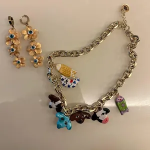 Detailed view of colorful dopamine style charm necklace and gold evil eye flower earrings.