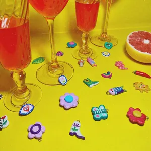Close-up detail of various colorful dopamine charms with fruit and wine glass props.