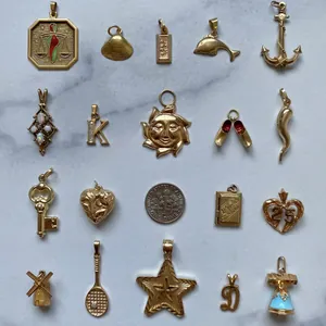 Collection of gold-plated stainless steel pendants in diverse shapes for jewelry making.