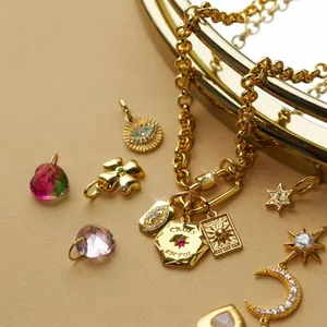 Detailed view of gold stainless steel evil eye and celestial charms on a chain