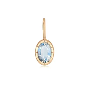 Close-up detail of a gold stainless steel pendant featuring a light blue oval zircon stone.