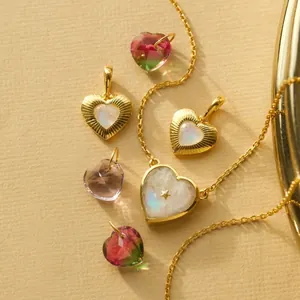 Detail view of gold-plated heart pendants featuring moonstone and a small star accent