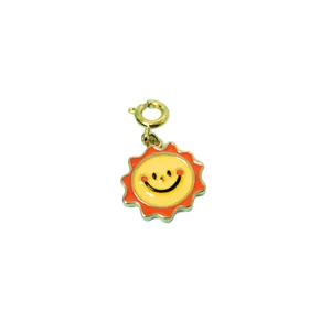 Colorful smiling sun pendant with red rays and yellow face on a gold-plated clasp
