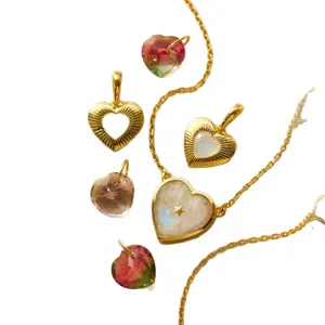 Elegant gold-plated stainless steel heart pendant necklace with faceted gemstones.