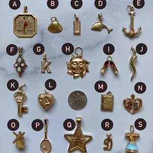 Selection of gold-plated stainless steel pendants featuring anchor, sun, and heart designs