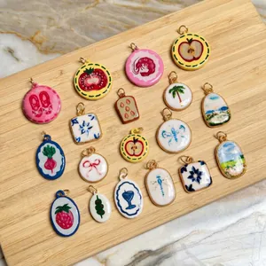 Assorted colorful summer-themed DIY pendants featuring various fruit and floral designs.