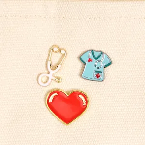 Set of enamel pins featuring a white stethoscope, nurse scrub, and large red heart
