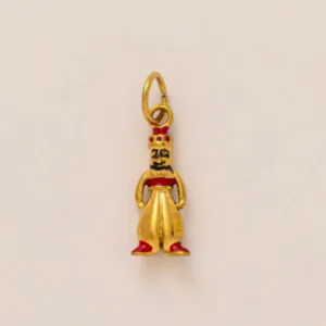 Close-up of a golden genie character pendant with red enamel details for DIY jewelry