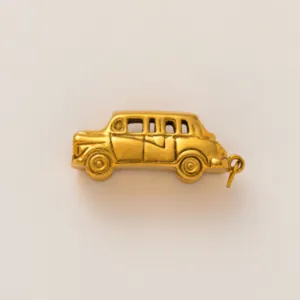 Close-up view of a vintage gold-toned car metal charm for creative DIY pendant projects