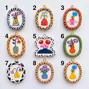 Group of nine hand-painted floral pendants with various animal print frame designs.