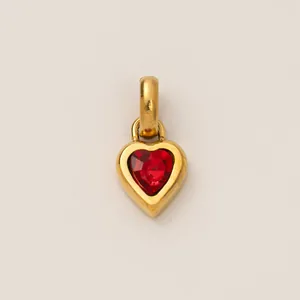Close-up detail of a heart-shaped titanium steel pendant with a vibrant red birthstone center