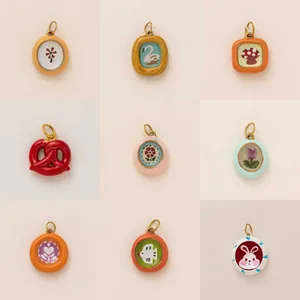 Selection of colorful DIY jewelry charms with cute patterns like rabbit, flowers and swan