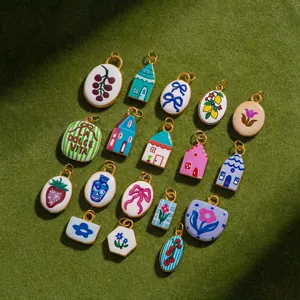 Collection of various colorful stainless steel charms featuring house and floral designs