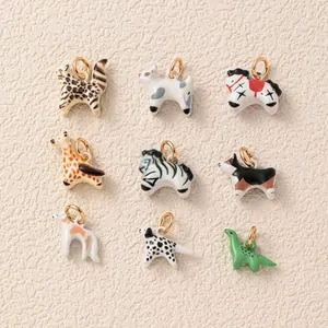 Detailed view of nine different colorful enamel animal charms on a textured background