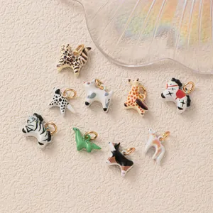 Close-up of colorful enamel animal charms featuring dinosaur, giraffe, and zebra designs.